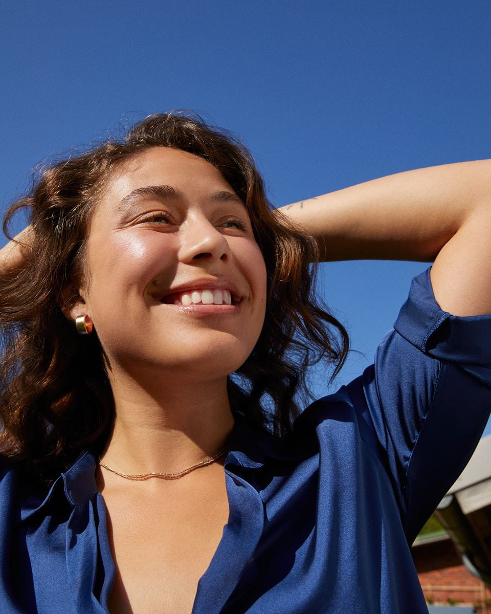 woman applying vegan skincare body lotion