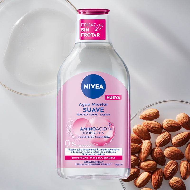 A bottle of NIVEA Micellar Water for Sensitive Skin lays on a purple bubble textured background.