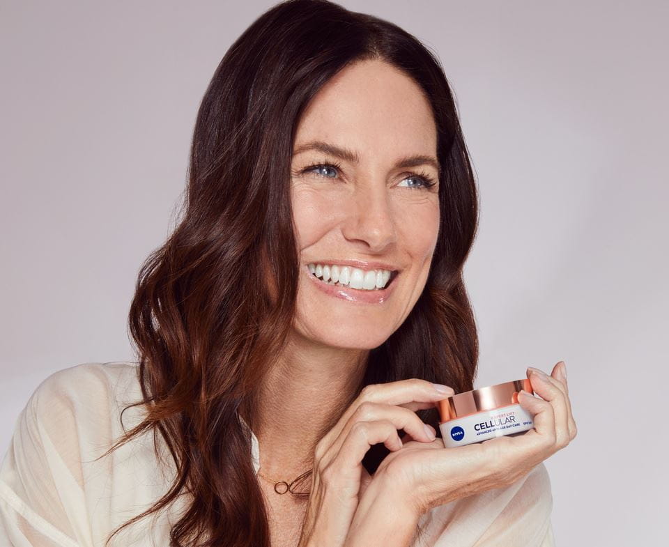 woman holding a Nivea Cellular Lift face cream